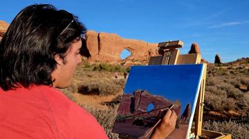 Immigrant and refugee artist paints landscape art.