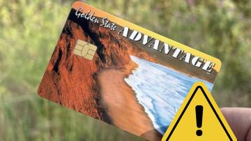 Photo of a California Electronic Benefit Transfer Card with a caution sign 