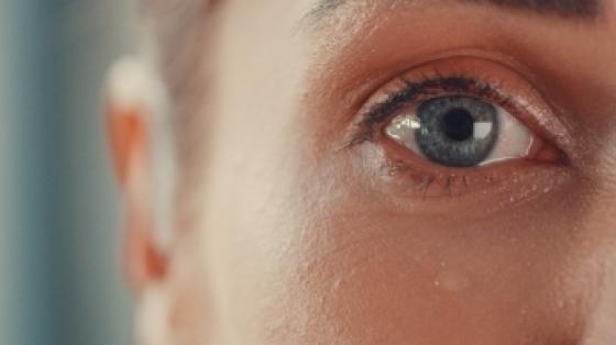 A close up shot of a woman's eye and a single tear